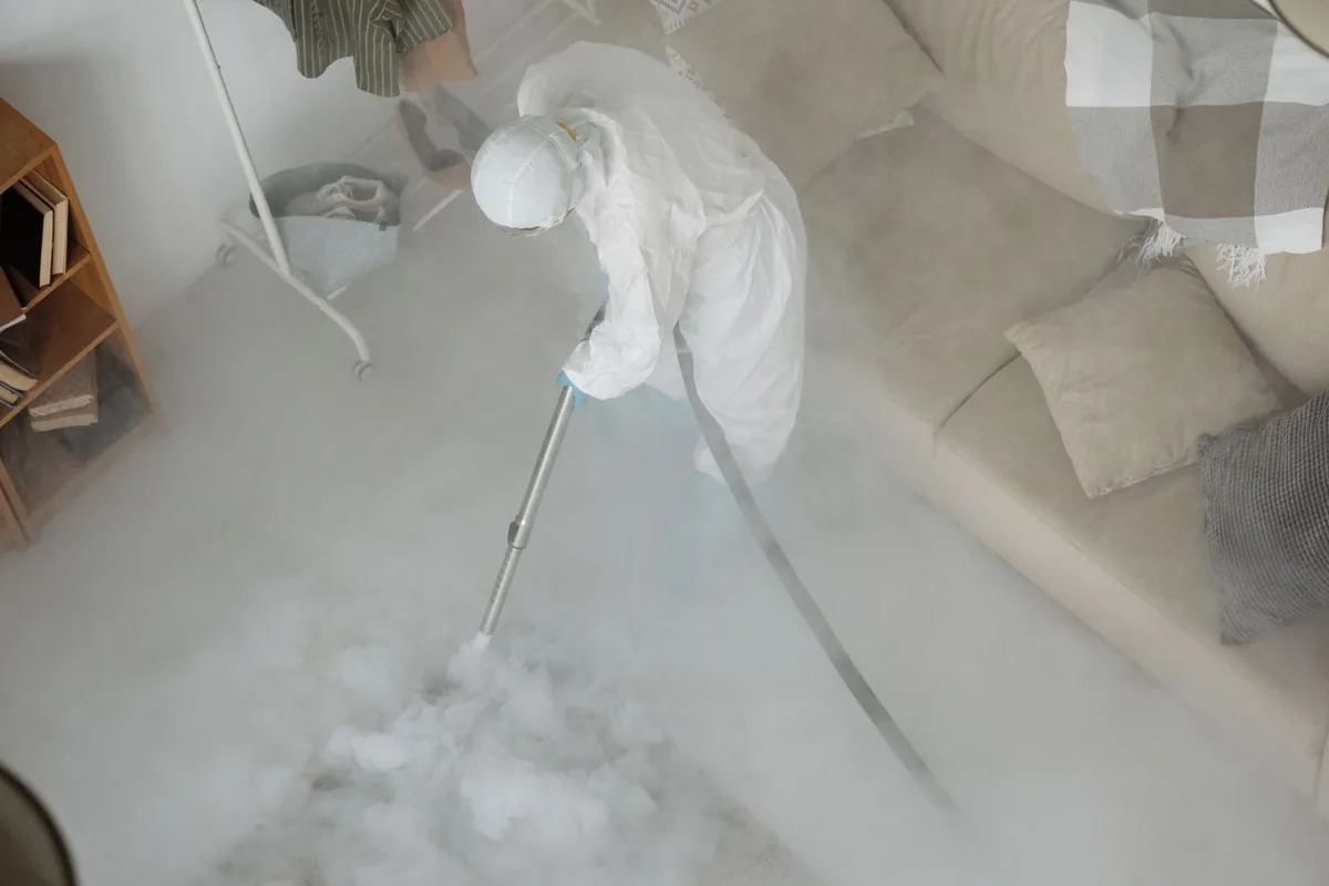 Biohazard cleanup technician in protective equipment, Hampden, ME